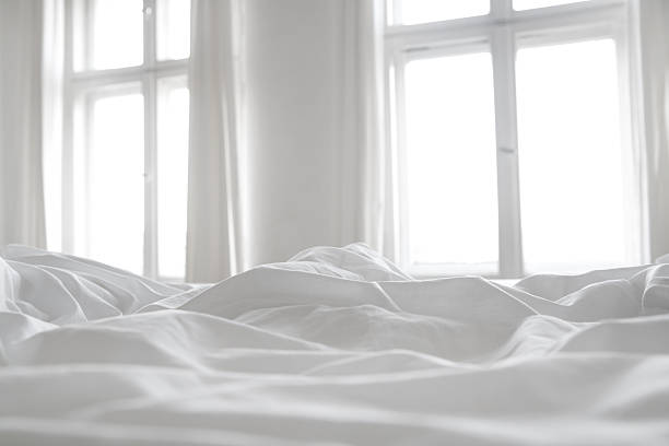 White bed linen White bed linen with two windows in the background.More like this: bedding stock pictures, royalty-free photos & images