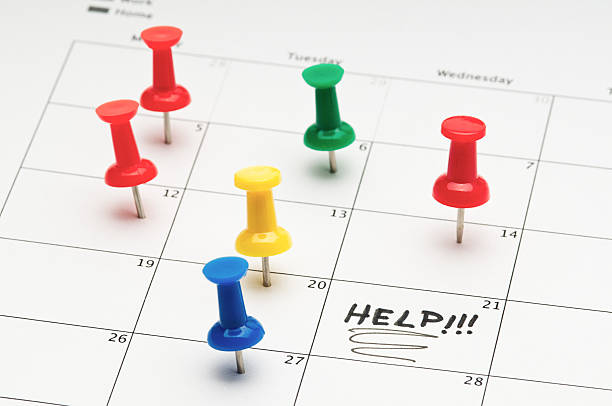 Busy schedule "Colorful pushpins in a calendar, marking a busy schedule . Stress concept.Click for more of my Thumbtack and Maps images." busy calendar stock pictures, royalty-free photos & images