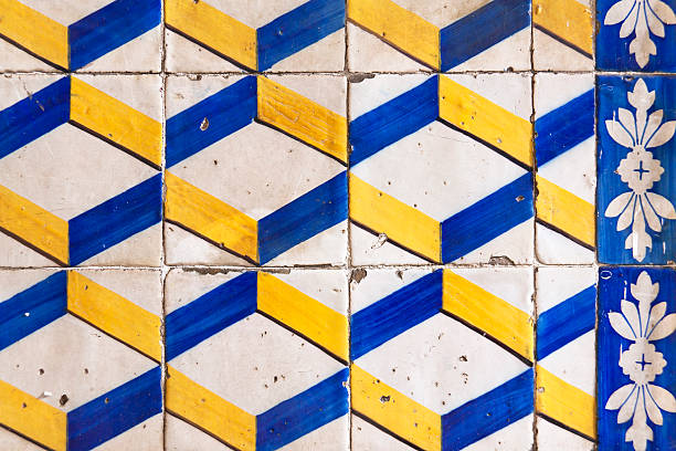 Wall of patterned tiles in vibrant yellow and blue colors on the facade of the Central Market Valencia, Spain.
