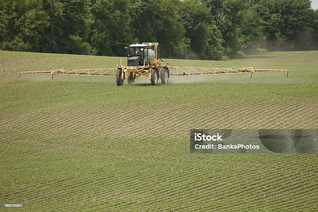 Boom spruzzatore applicazione di pesticidi in primavera campo di soia - Foto stock royalty-free di Diserbante - Macchina agricola