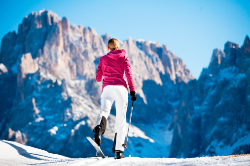 Young woman while cross-country skiing in the dolomite alps.