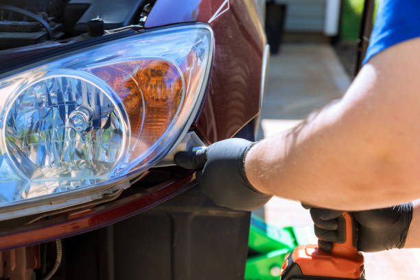 istock Repairman assembling an automobile a headlight on car during car repair 1850116234
