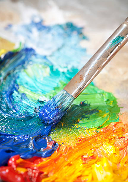 istock Paintbrush with oil paint on a classical palette 185012032