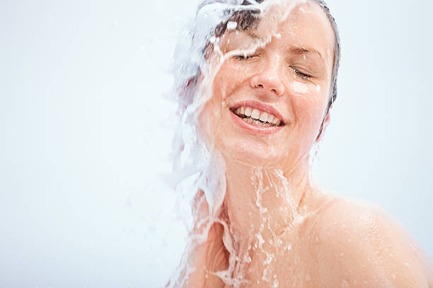 istock young woman having a shower 185012066