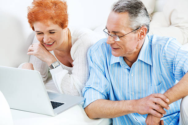 istock Beautiful mature couple using laptop at home. 185012105