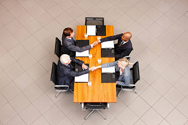 istock Business People Shaking Hands Over a Conference Table 185012110