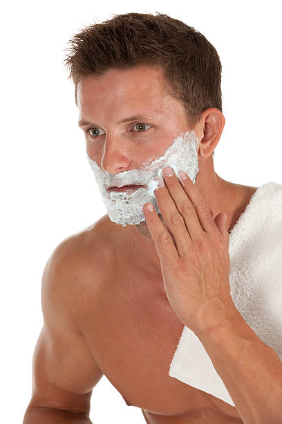 istock Smart young man applying shaving cream to his face 185012313