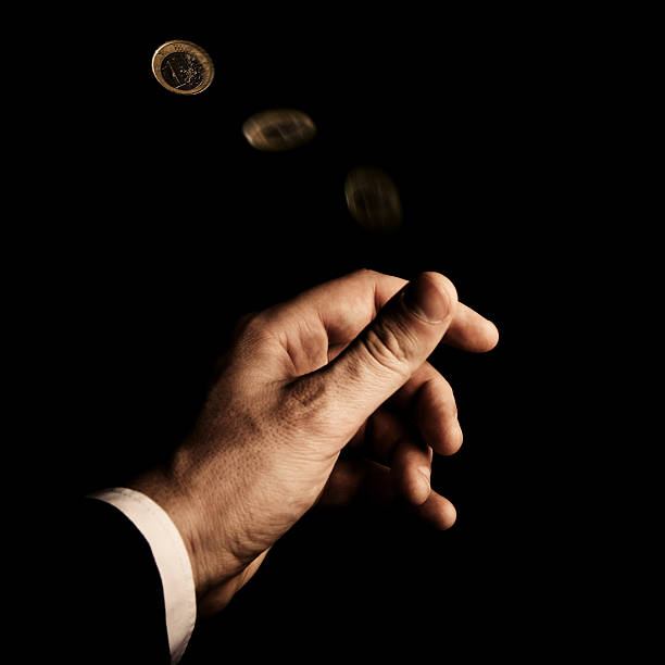istock Flipping the Euro coin 185012362