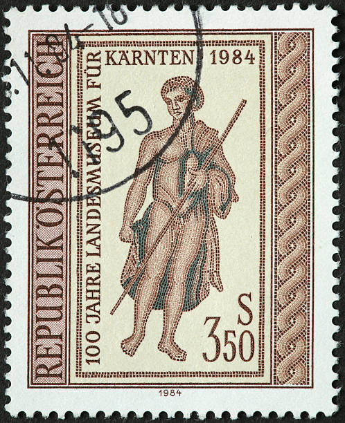 istock classic figure with staff on old Austrian stamp 185012372