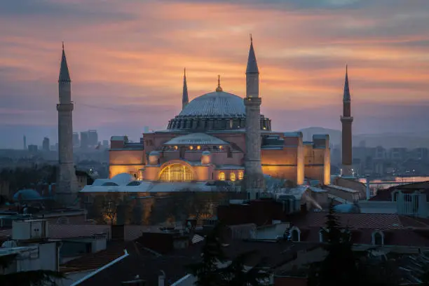 View of the Hagia Sophia Grand Mosque from the roof of the house against the background of the dawn sky on a foggy morning, Istanbul, Turkey