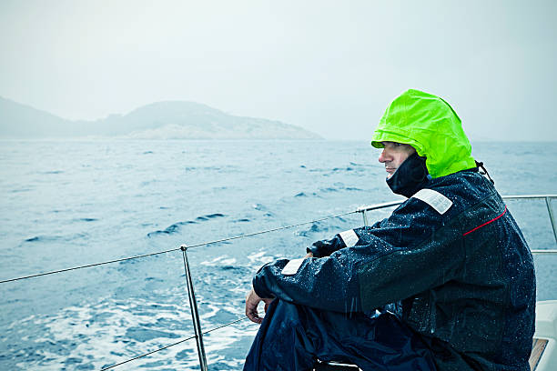Sailor sailing in rainy weather.