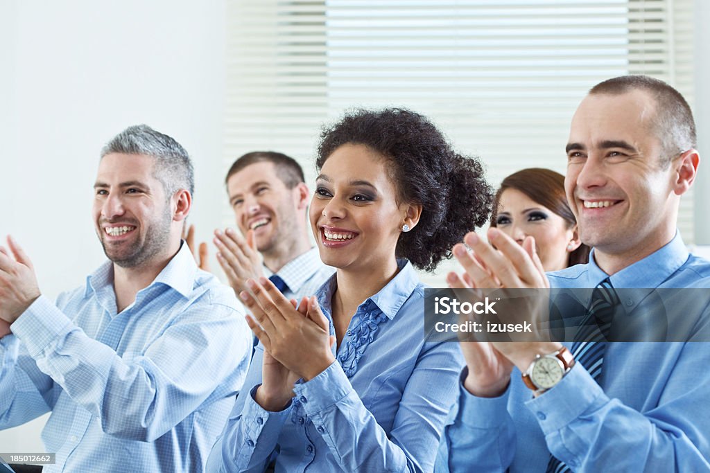 Applauding audence Group of laughing business people during business seminar, clapping their hands. 30-34 Years Stock Photo