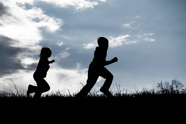 istock Silhouette of Children Running 185012727