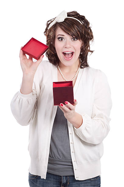 женщина, открытие красный подарочная коробка с бантом - bow looking at camera waist up indoors стоковые фото и изображения