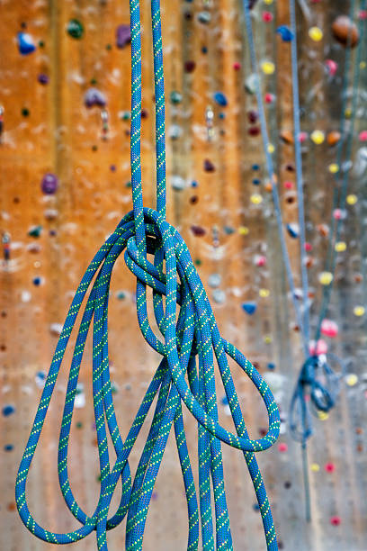 istock Blue patterned rope hanging in front of a climbing wall. 185012815