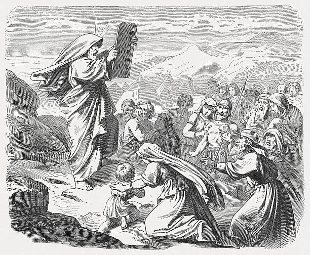 Moses with the New Tablets (Exodus 34, 29-33) "Now when Moses came down from Mount Sinai with the two tablets of the testimony in his hand aa when he came down from the mountain, Moses did not know that the skin of his face shone while he talked with him. When Aaron and all the Israelites saw Moses, the skin of his face shone; and they were afraid to approach him. But Moses called to them, so Aaron and all the leaders of the community came back to him, and Moses spoke to them. After this all the Israelites approached, and he commanded them all that the Lord had spoken to him on Mount Sinai. When Moses finished speaking with them, he would put a veil on his face. (Exodus, Chapter 34, 29-33). Woodcut after a drawing by Julius Schnorr von Carolsfeld (German painter, 1794 - 1872) from my archive, published in 1877." mt sinai stock illustrations