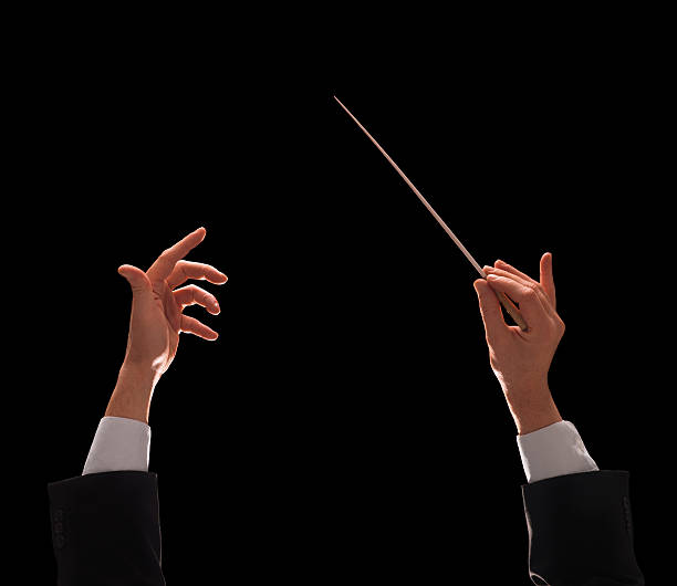 conducting buttons Concert conductor hands with baton isolated on black background conductors baton photos stock pictures, royalty-free photos & images