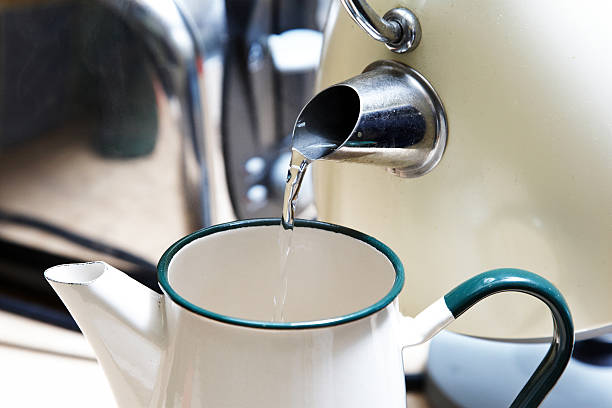 istock Boiling water from kettle into coffee pot 185013195