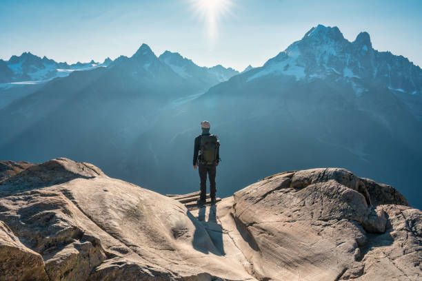 a male hiker enjoying the mont blanc mountain view during trail of lac blanc at france - white lake imagens e fotografias de stock