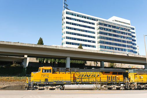 Tacoma, Washington, USA. The locomotive of a freight train in the city center rides on the railway