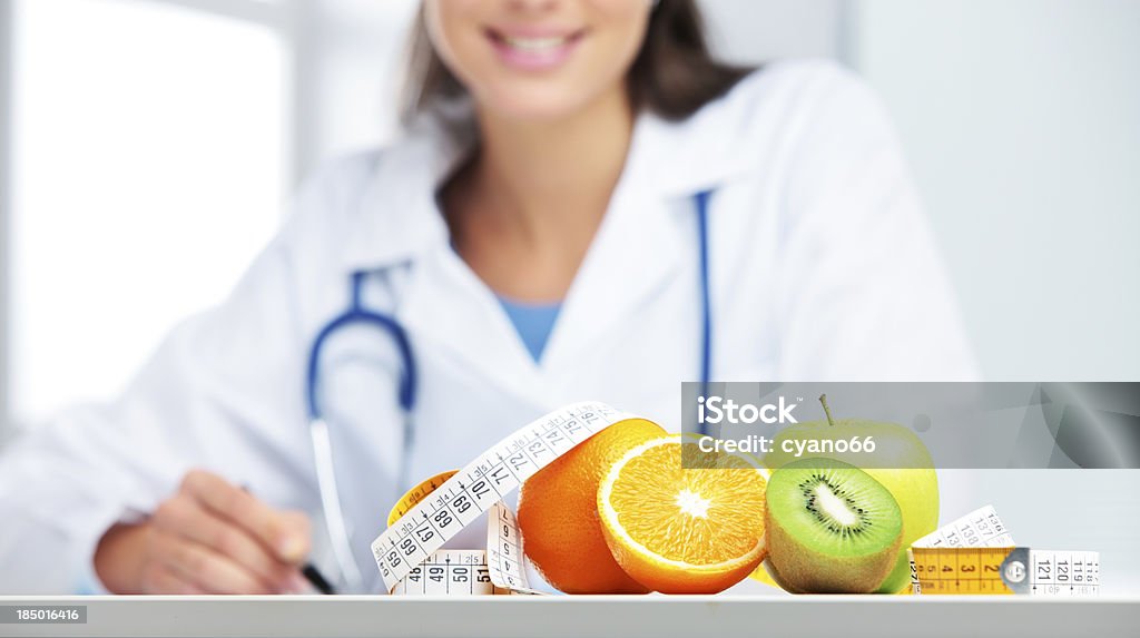 Nutritionist Doctor Nutritionist female Doctor in her office. Focus on fruit Nutritionist Stock Photo