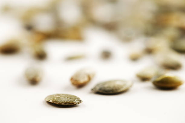 istock Organic green pumpkin seeds against a white background 185017662