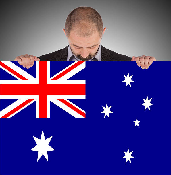 istock Businessman holding a big card with flag 185018938