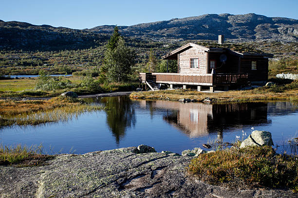 small cottage at norwegian lake stock photo