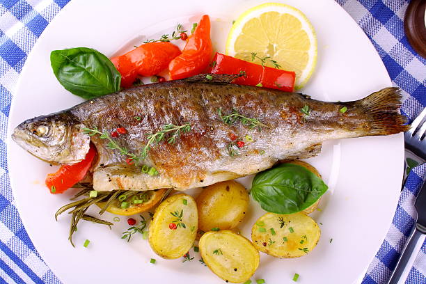 istock Grilled rainbow trout with potato, basil, red pepper and lemon 185022475
