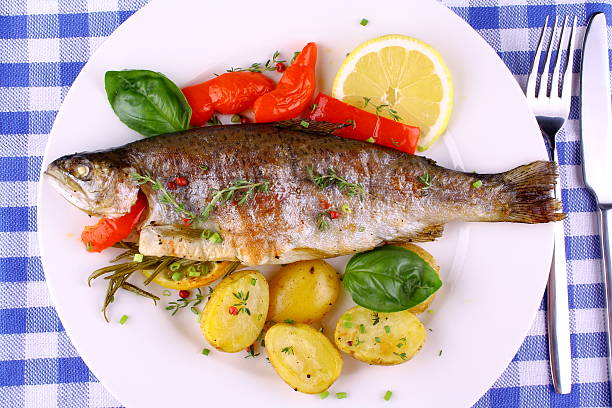 istock Grilled rainbow trout with red pepper, potato and rosemary 185022637