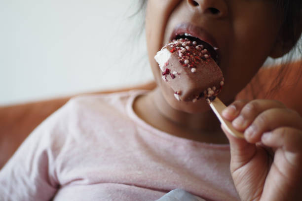 istock Child Hand Holding Ice Cream 1850235082