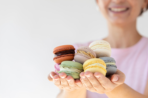 A woman showing macaroon.
