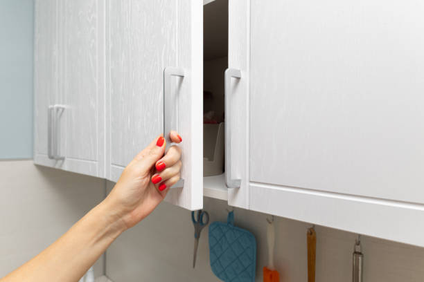 istock female hand opens kitchen cabinet with utensils 1850240451