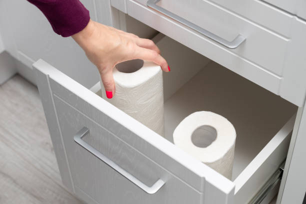 istock woman taking out paper towel from kitchen drawer. 1850243224