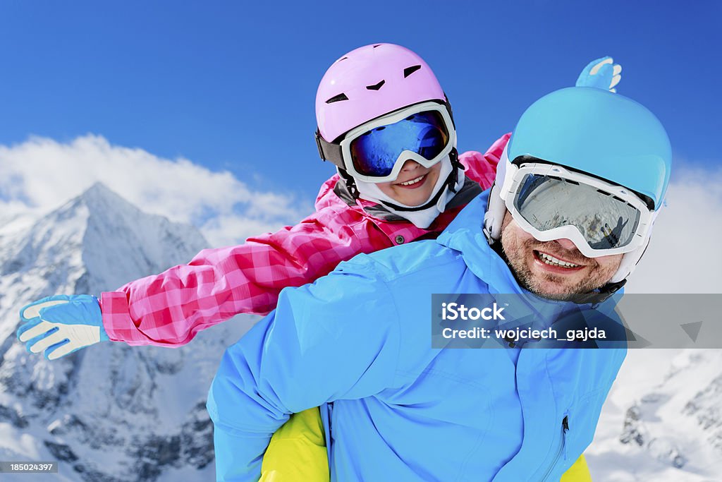 Family enjoying winter Ski, winter, snow, skiers, sun and fun - family enjoying winter vacations Activity Stock Photo