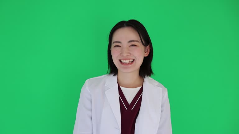 Confident Female Medical Professional Smiling With Green Screen Background