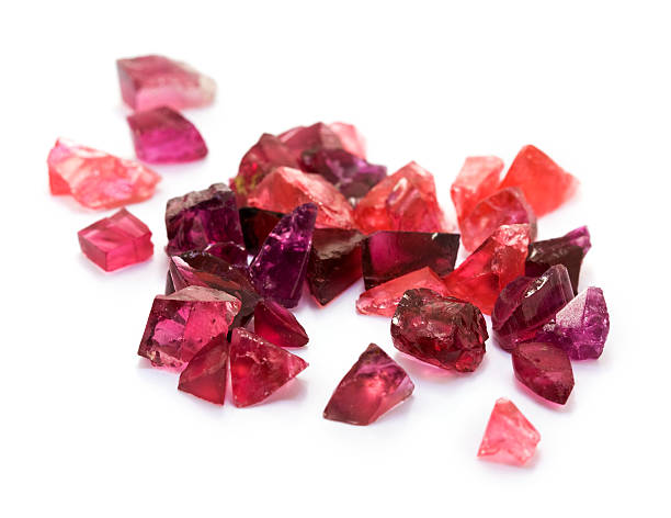 Purple and red tourmaline gemstones, Closeup picture of natural purple, pink and red tourmaline gemstones on the white background. garnet stock pictures, royalty-free photos & images