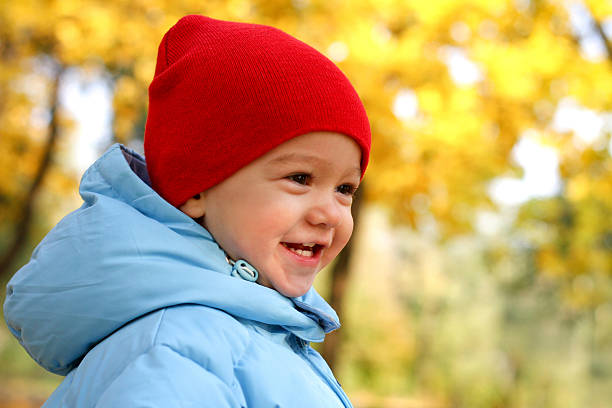 Caucasian Little boy wearing a hoodie behind bars
