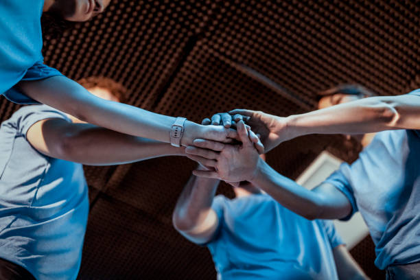 istock Cyber Sport Gamers Putting Hands Together 1850278679