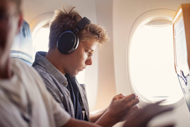 istock Teenage boy travelling by plane 1850284926