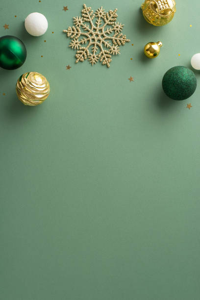 istock Chic holiday vibe. Top view vertical image showcasing lavish ornaments, delicate snowflake, sparkling gold sequins on soft green-colored backgroundâperfect for conveying wishes or promotional content 1850291721
