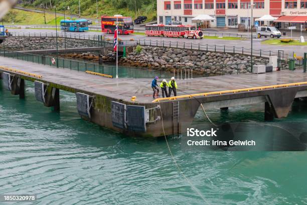Oldens Port Terminal And Buses View Of Oldens Lively Waterfront With Tour Buses And A Gift Shop Workers At Olden Pier Stock Photo - Download Image Now