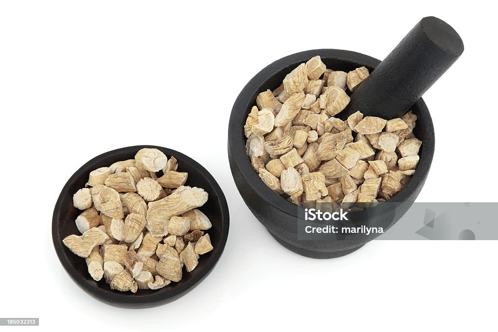 Ginseng Korean ginseng chinese herbal medicine in a mortar with pestle and bowl. Panax schinsen, ren shen. Alternative Medicine Stock Photo