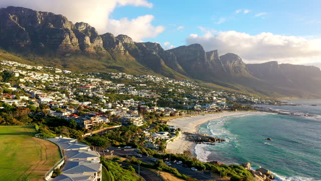 Drone of beach, mountains and city background for tourism destination, travel or architecture with landscape. Aerial view of holiday houses, ocean and sea or coast location in Cape Town, South Africa