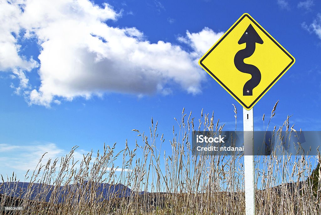 Traffic sign over dry grass Traffic sign over dry grass and blue sky Autumn Stock Photo