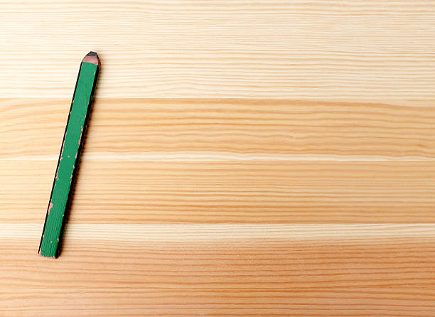 istock Green carpentry pencil on wood 185034559