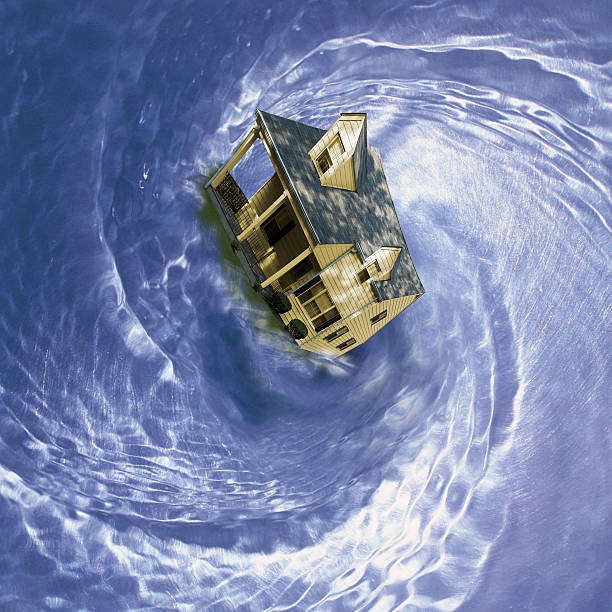 istock house in spinning whirlpool 185035964