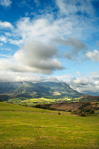 istock Landscape with green fields, mountains and clouds in the sky 185037234