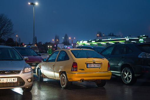 Licensed copy of Opel Kadett E - Daewoo Nexia (Cielo, Racer) with rare body 3-door hatchback in yellow color is parked in Subotica, Serbia, 07.12.2023