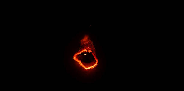 istock burning paper, glowing edge of paper on a black background 1850395471